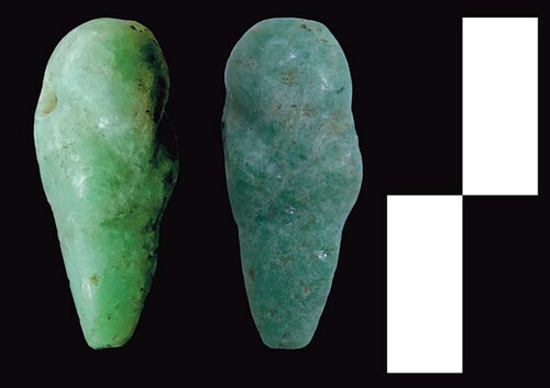 Figure 10. Miniature jade celtiform pendant in the form of an abstract avian personage.