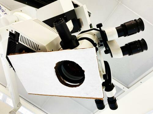 Figure 2 Water-contact indicator tape of 15x25cm with an 8cm diameter hole was mounted on the surgical microscope to detect aerosol contact.