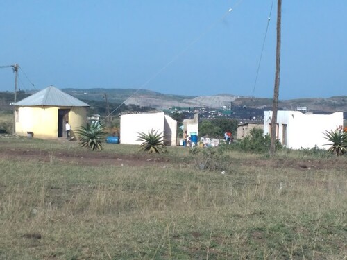 Figure 3. Somkhele residents in proximity to mining in the background.