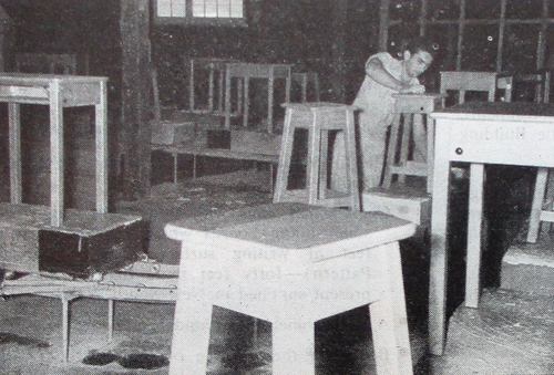 Figure 2. Rubbing down furniture after it has been sprayed and dried at the Furniture Centre.