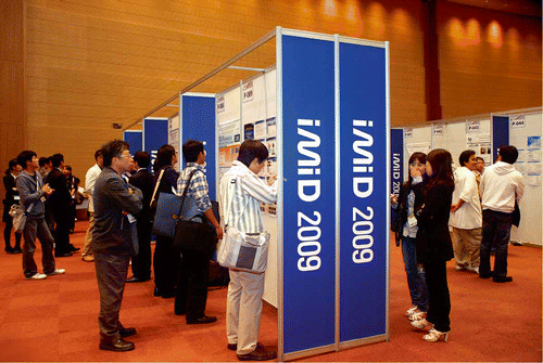 Figure 4. Delegates studying the most recent results during the poster session.