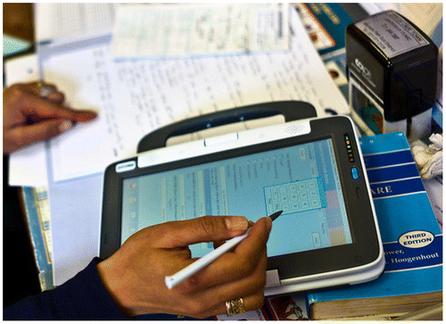 Figure 1: Nurse using the convertible classmate personalised computer tablet with stylus.