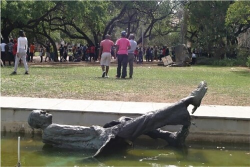 Figure 2. The dismantled sculpture of State President C R Swart on the Bloemfontein campus of the University of the Free State, South Africa, supine in the pond in front of the Main Building of the UFS Bloemfontein campus, on 22 February 2016. Photographer: Lesego Motsiri. Image courtesy of the UFS Art Gallery.