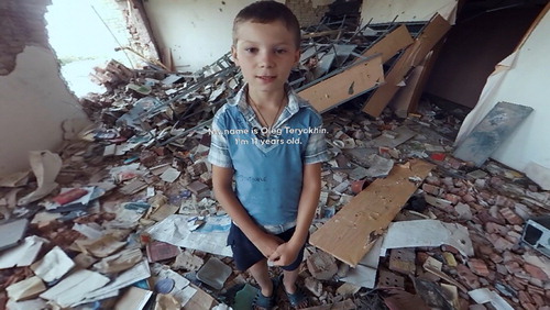 Figure 1. The Displaced (NYT). Ukrainian Oleg standing in the ruins of his school.