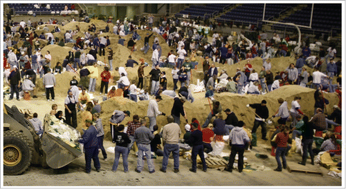 Figure 3. Fargo, North Dakota's “flood fighters” in action, filling sandbags in the Fargo Dome during the peak river rise in 2009. Photo by Andrea Booher/FEMA. http://www.fema.gov/media-library/assets/images/55263.