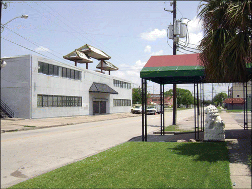 Fig. 5. Empty building with Chinese-style rooftop along St. Emanuel Stree, Old Chinatown. Lion statue at right guards the entrance to an abandoned Asian restaurant.