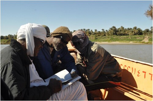 Figure 3. Workers from Ernetta island (in background) with the 2014 book.