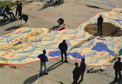 Figure 3. Residents of the Ararat painting the map of Kurdistan on the ground in the light of the Newroz festival. 2002. Photo: Paolo Bruschi.
