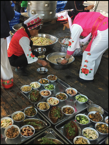 Figure 2. Local villagers in ethnic costumes prepare food for visitors. Source: Author.
