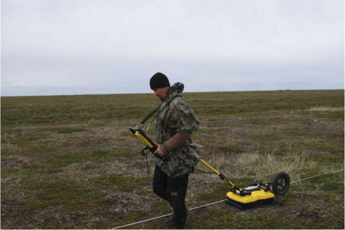 Fig. 4  The site presented a flat surface free of obstructions, making the deployment of geophysical instruments very easy. Shown here, Thomas Urban with Noggin ground-penetrating radar system. (Photo by Christopher Wolff.)