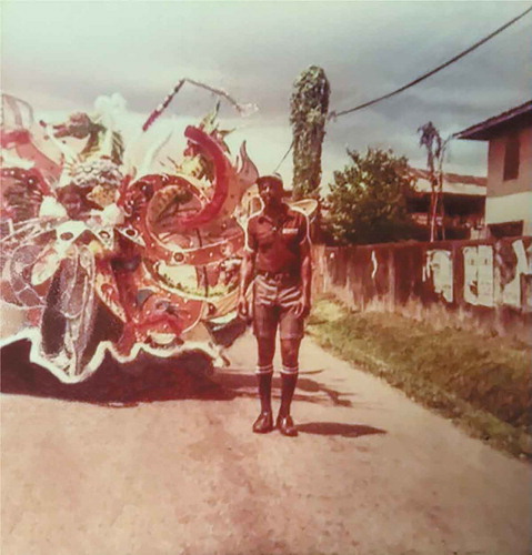 Figure 6 Jamila’s grandfather, Valentine Ferdinand, in Point Fortin, Trinidad, ca. 1980, standing beside his hand-made Carnival costumes