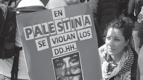 “In Palestine, human rights are violated,” reads a Palestinian-Chilean demonstrator’s sign in Santiago, Chile. PINTEREST