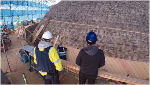 Figure 3. The carpenters explain the cladding to the author (on right). Note the scale of the rotunda.