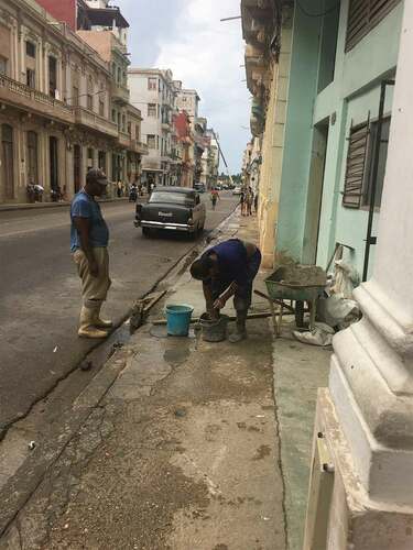 Figure 4. Two construction workers transforming a residential complex in Old Havana into a private hotel.