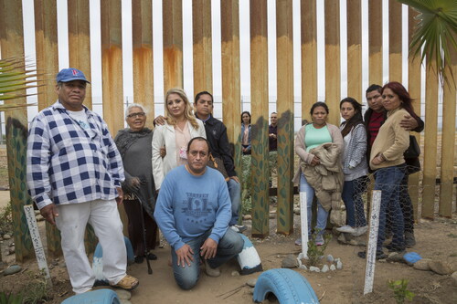 Figure 3. Griselda San Martin, The Wall, 2015–16. The Salgado family poses for a portrait. Cesar Salgado and his niece Giselle visit with several family members in Tijuana, and Cesar saw his daughter for the first time in 14 years, only it was through the beams of the border wall. Photograph © Griselda San Martin.