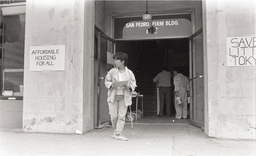 Figure 2. Student volunteers from UCLA, USC, and UCI work to restore the San Pedro Firm Building on May 28, 1988. Photograph by Abraham Ferrer © Visual Communications Archives.