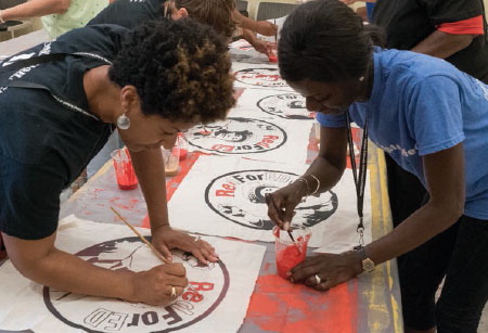 Figure 2 (middle). Maryland educators paint patches and posters that will be tools with which to advocate for investment in public education.