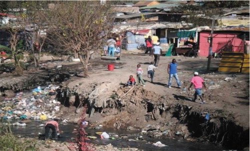 Figure 10. Children playing in the Stream while a resident collects water.Source: Author’s Photograph, May 2014.