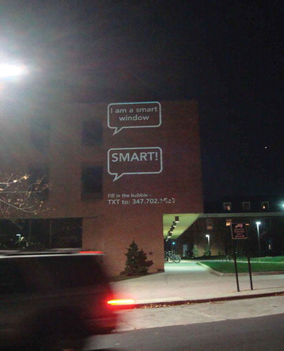Figure 2. Paul Notzold’s text message art project, TXTual Healing, projected onto the side of a building on the University of Maryland, College Park campus in November, 2011.