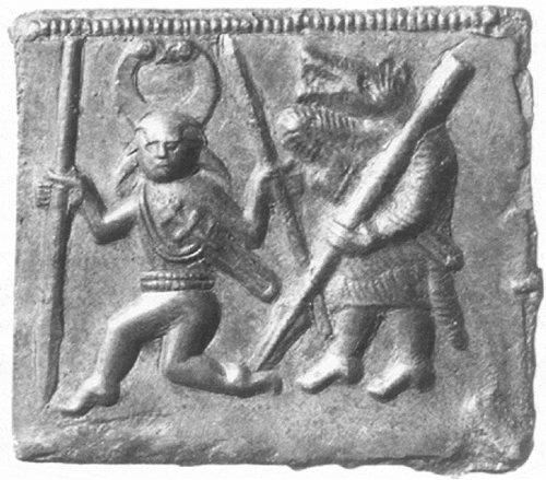 Figure 2. Plate D of the Torslunda Die Matrix (500–700 AD). This foil depicts a horned, naked male figure—suggested to be Odin—dancing while wearing a sheathed sword and wielding two spears, one angled upward and another angled downward. Much like Figure 1, the figure’s feet is presented as if he had just leapt forward, interpreted as dance. This example, however, portrays the dancer with a spear-bearing warrior wearing a wolf-skin. This may suggest that this picture portrays the Norse god Odin leading a mortal warrior of the wolf-warrior group in the weapon dance. As a result it portrays the function of animistic transformation attributed to Odin and the weapon dancer ritual, in which the participated wolf-warrior would be granted the ability to transform into a wolf, lending him its predatory strength and speed. (Stjerna 1903)