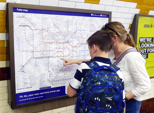 Figure 8. Travellers using a wall-mounted Tube map to plan a journey at Regent’s Park Underground Station in 2021. Photograph by the author and included with the permission of TfL.