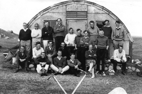 Figure 3. The participants of the Quaternary Field Study Group (latterly QRA) at the Breida Hut during the 1968 field meeting. Back row standing on benches, from left to right: L. Penny, W. Thorns, R.J. Rice, R. Johnson, G. Saunders, A. Orchard, E. Brooks. Middle row from left to right: K. Clayton, T. Finch, G.F. Mitchell, R.J. Price, (seated), D. Mottershead, P. Howarth, P. Triccas and unnamed (standing). Front row from left to right: C. Embleton, E.A. Francis, J.G. Smart, D. Peacock, J. Thornes