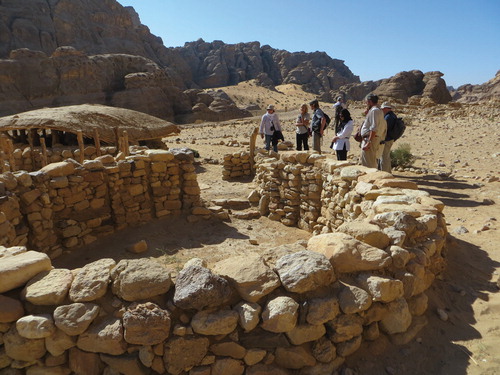 Fig. 4:. Visitors discussing the reconstructed neolithic structures at Beidha, near Petra—a site on the proposed Neolithic Heritage Trail and part of the CBRL’s DEEPSAL project. Photo: Carol Palmer