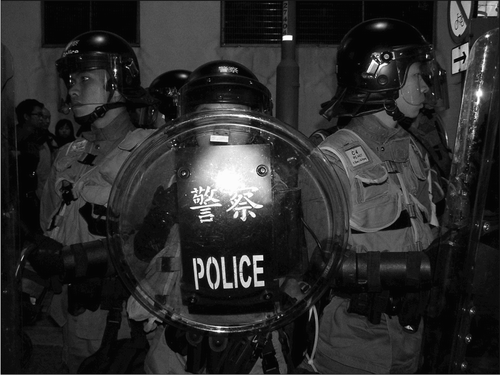 Fig. 7. As the anti-WTO protests intensified, more police were seen in full riot gear. 18 December 2005.