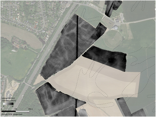 Figure 11. Apparent conductivity data from FDEM survey at the battlefield of Waterloo. Dashed lines indicate colluvial deposits (eroded soils) mapped in the mid-20th century (Louis Citation1958). These correlate with low-conductivity (lighter-toned) features in the FDEM dataset, providing more detail on the distribution of these deposits.