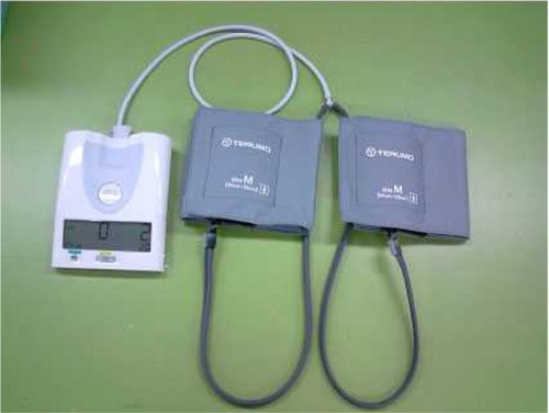 Figure 1 Our custom-made RIC device, showing the body of the system (left) and 2 blood-pressure cuffs connected to the system (right).