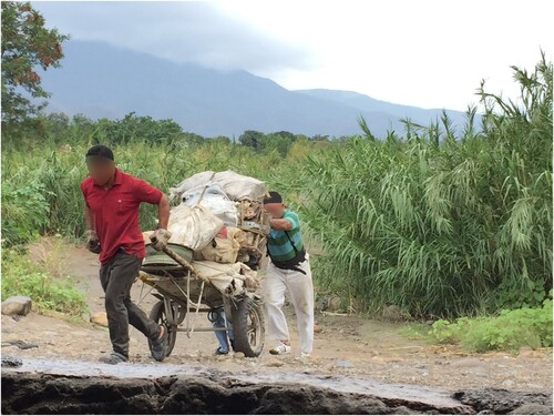 Figure 5. Informal cross-border trade: Colombian Maleteros using carts to carry goods between Colombia and Venezuela across the trocha. Source: Photograph by Yvonne Riaño, La trocha, 2019.