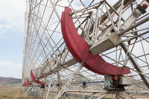 Figure 3. An overall image of the East-West arm of the Molonglo radio telescope showing the length and complexity of the metal structure and the motors and gearing systems required to make it move. Image: Wain, 2018.