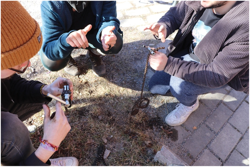 Figure 3. Volunteer (middle) explaining how to break and reconnect a bicycle chain with a chain breaker tool.