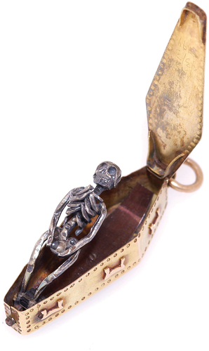 Figure 8. A gold memento mori pendant, used to remind the user of the transience of life and material luxury, containing a decaying corpse inside a coffin. (Open). Wellcome Collection. Attribution 4.0 International (CC by 4.0).