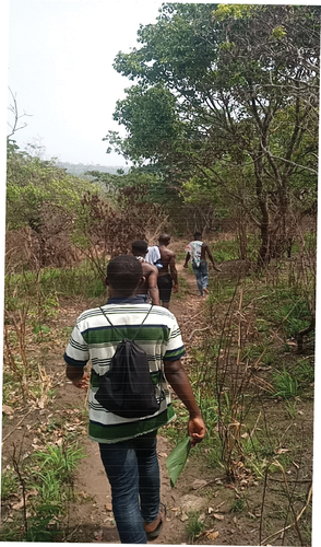 Figure 2. The researcher hikes through the mountainous pathways to interview aba-oke residents.