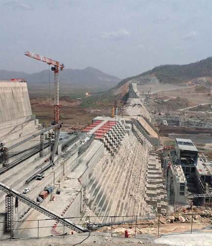 FIGURE 16 The Grand Ethiopian Renaissance Dam (GERD) under construction across the Blue Nile. This enormous river engineering project, funded entirely by Ethiopia and strenuously opposed by Egypt, is a source of national pride in Ethiopia and projects riparian power across the region (Smith Citation2020). [Power; Natural capital] (Photo by Gedion Asfaw, 2018).