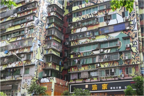 FIGURE 3. Multi-storey apartment houses in Chongqing’s art district Huangjueping and the display of public art within the built fabric of the city. Source: Madlen Kobi (2017).