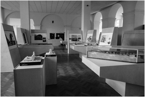 Figure 3. Perspective on part of the exhibition urban room area showing models, photo and story boards, and general layout. Source: authors.