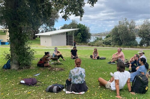 Figure 1. Milstein and Gendelman worked in partnership with Latoya Brown, descendant of the Dhawarral, Walbunja, Djiringanj, and Gunai/Kurnai peoples and owner of Kadoo Indigenous Experiences, to immerse university educators in place-based knowledges and care. Photo by Irina Gendelman.