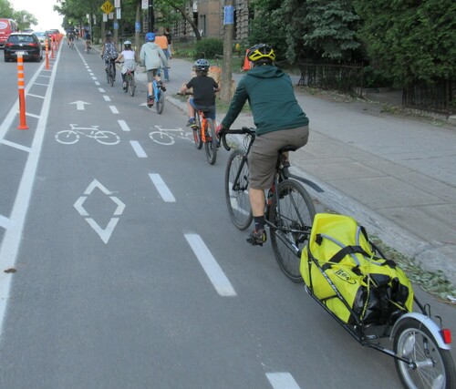 Figure 3. Montreal installed 88 km of new or improved cycling facilities in 2020, of which 29 km were temporary COVID lanes, as shown here. Most of the new facilities were physically separated from motor vehicle traffic, thus encouraging use by all ages, including entire families.Source: Photo by Bartek Komorowski