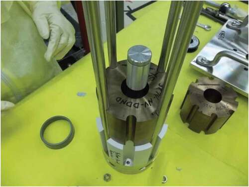 Fig. 2. Bottom BeO reflector and one uranium core component. Neutron source is in the aluminum capsule.