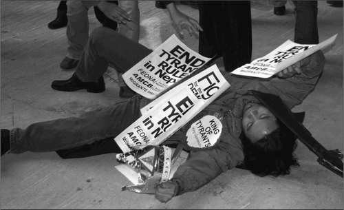 Fig. 1. At the Nepalese Consulate, the first stop for the Consulate Hopping Protest, a migrant worker dressed as King Gyanendra was presented with the “King of Tyrants” award and then knocked to the ground. 1 5 December 2005. (Credit: Peter C. Alter)