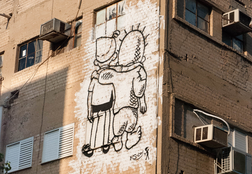 Graffiti by Yuval Caspi (2020) in Kiryat HaMelaha Tel Aviv. Based on two famous national cartoons: Srulik of Kariel Gardosh who represents Israel and Handala by Naji al-Ali who represents the Palestinian people. CC BY 4.0 <https://creativecommons.org/licenses/by/4.0>, via Wikimedia Commons.