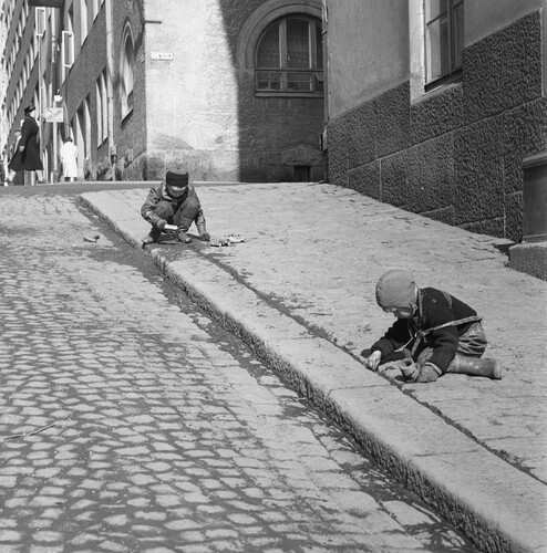 Figures 4–6. (4) Two boys standing on the barbed wire fence between the yards in Kallio neighbourhood, Helsinki, in 1970, Simo Rista, Helsinki City Museum. CC BY 4.0.; (5) Children climbing on a rug beating rack and playing in the yard of an apartment building in the neighbourhood of Roihuvuori, Helsinki, in 1970, Eeva Rista, Helsinki City Museum. CC BY 4.0; and (6) Young boys engaged in street play during the spring of 1962, Teuvo Kanerva, Finnish Heritage Agency [Museovirasto, Historian kuvakokoelma]. CC BY 4.0.