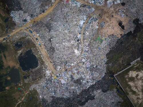Figure 6. Aerial photograph of the garment dump and trucks (Photo by Thomas Cristofoletti; copyright RHUL).