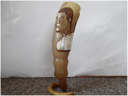 Figure 4. Cow horn drinking cup decorated with facial image of renowned act, Bruce. Carver, Pa Mandzie, Baba Kingdom, Bamenda Grassfields, Cameroon, December 2015.