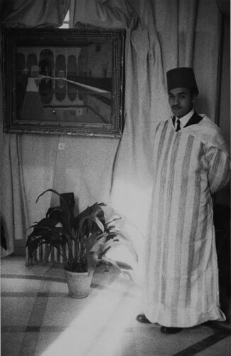 Figure 4. Anon., Mohamed Sarghini exhibiting his works in the Dirección General de Marruecas y Colonias, c. 1947, photograph. Biblioteca Nacional de España. GC-CARP/382/2/9.
