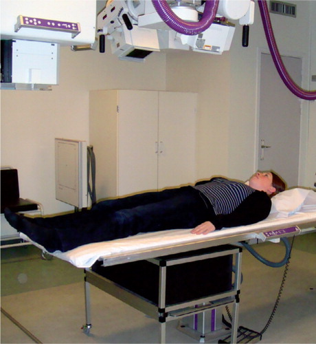 Figure 19. The RSA set-up with the patient positioned supine on the examining table and a calibration box underneath creating a 3D coordinate system of tantalum markers.
