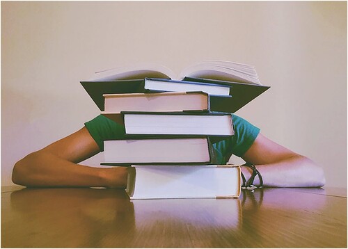 Figure 5. Stock image of person behind large stack of books.