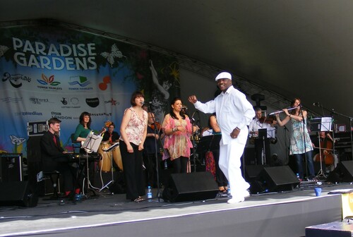 Figure 2. Sue Miller (on flute) and her Charanga del Norte with dancer Guillermo Davis (centre in white) performing at Victoria Park, London supporting Orquesta Aragón, 21 June 2009.